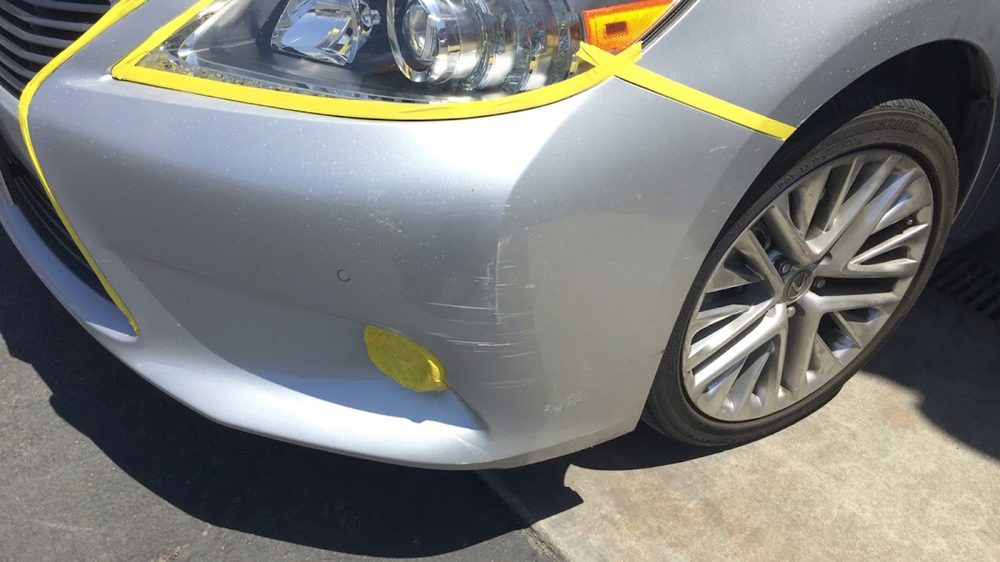 Silver Lexus bumper during bodywork prep