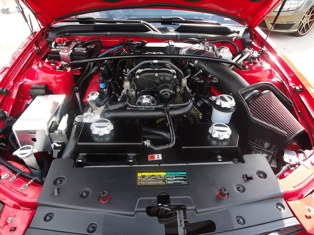 Engine bay of a red Ford Mustang